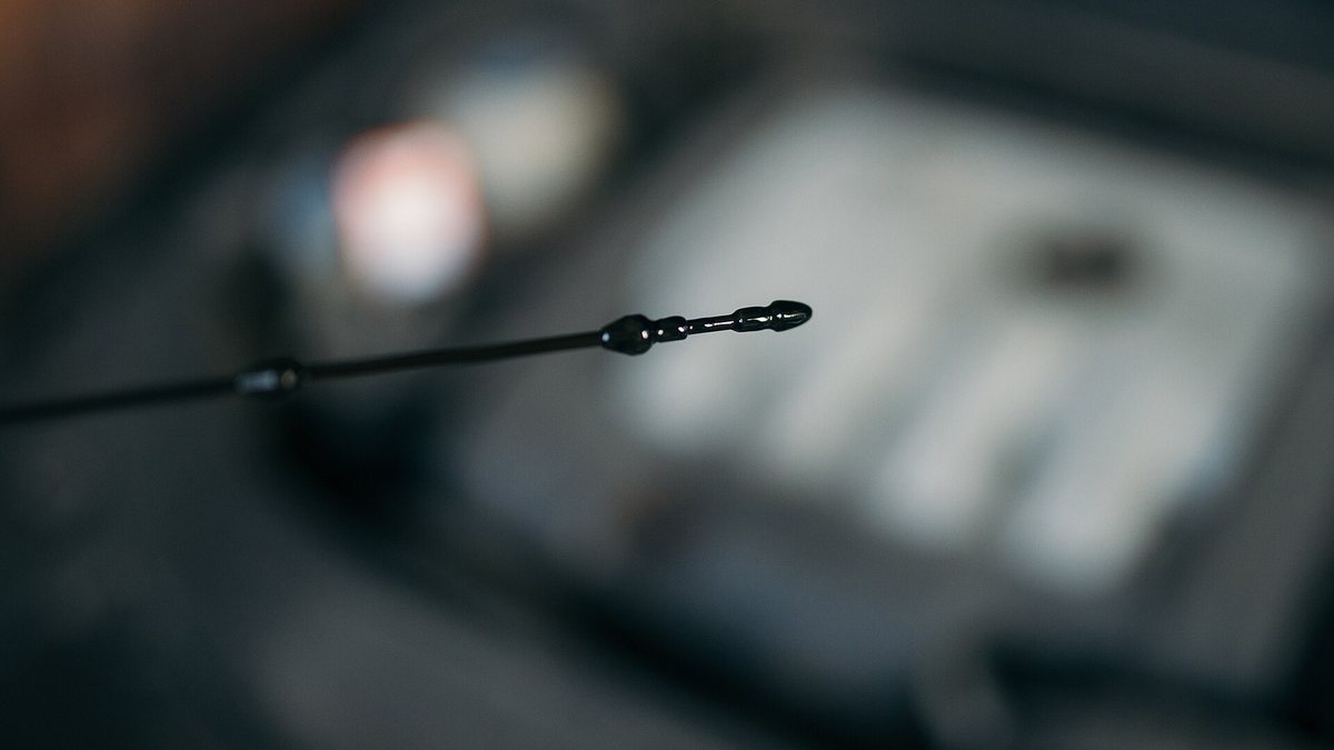 Checking the oil level in a car engine
