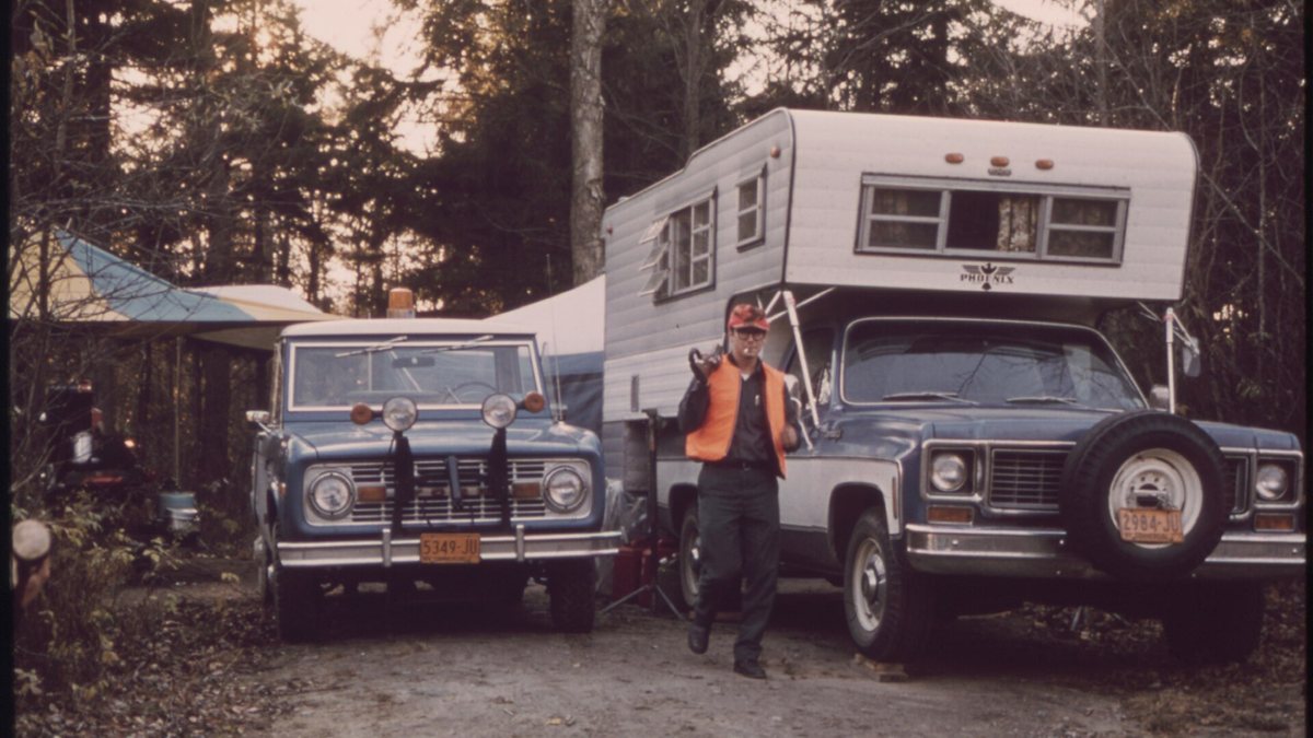 EQUIPMENT USED BY HUNTERS IN THE ADIRONDACK FOREST PRESERVE FOR BIG GAME INCLUDES FOUR WHEEL DRIVE VEHICLES AND CAMPERS MOUNTED ON PICKUP TR