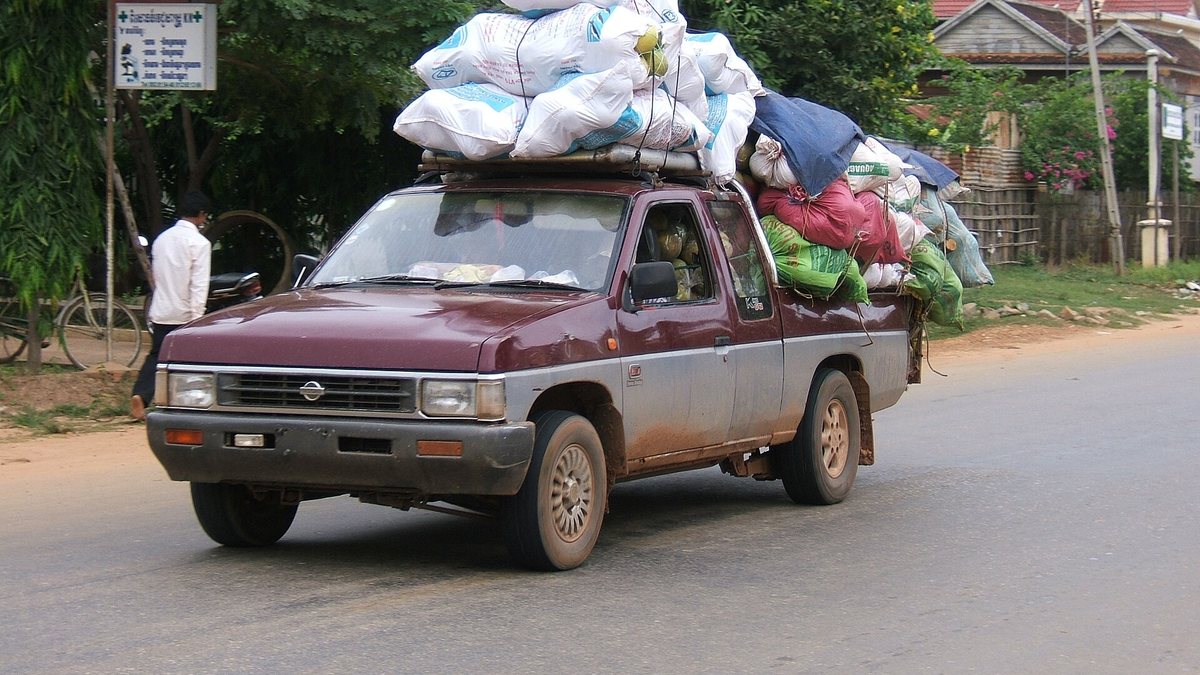 A heavily loaded pickup truck brings in produce to the Siem Reap central market